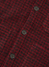 A close-up view of a model wearing the Black/Red 533 Wool Mix Cardigan, detailing the V-neckline, front buttons, and high-contrast black and red wool blend pattern against a studio background.
