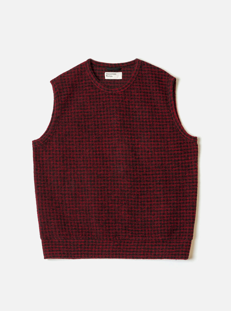 A full-length front view of a model wearing the Black/Red 533 Wool Mix Giacomo Tank Top in a studio setting, featuring a sleeveless vest design with a bold black and red pattern and ribbed edges.