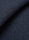 A macro fabric swatch shot of the Navy Techno Melton Plain Tag Jacket set against a plain white backdrop, highlighting the tight weave, matte surface finish, and deep navy hue of the techno melton material.