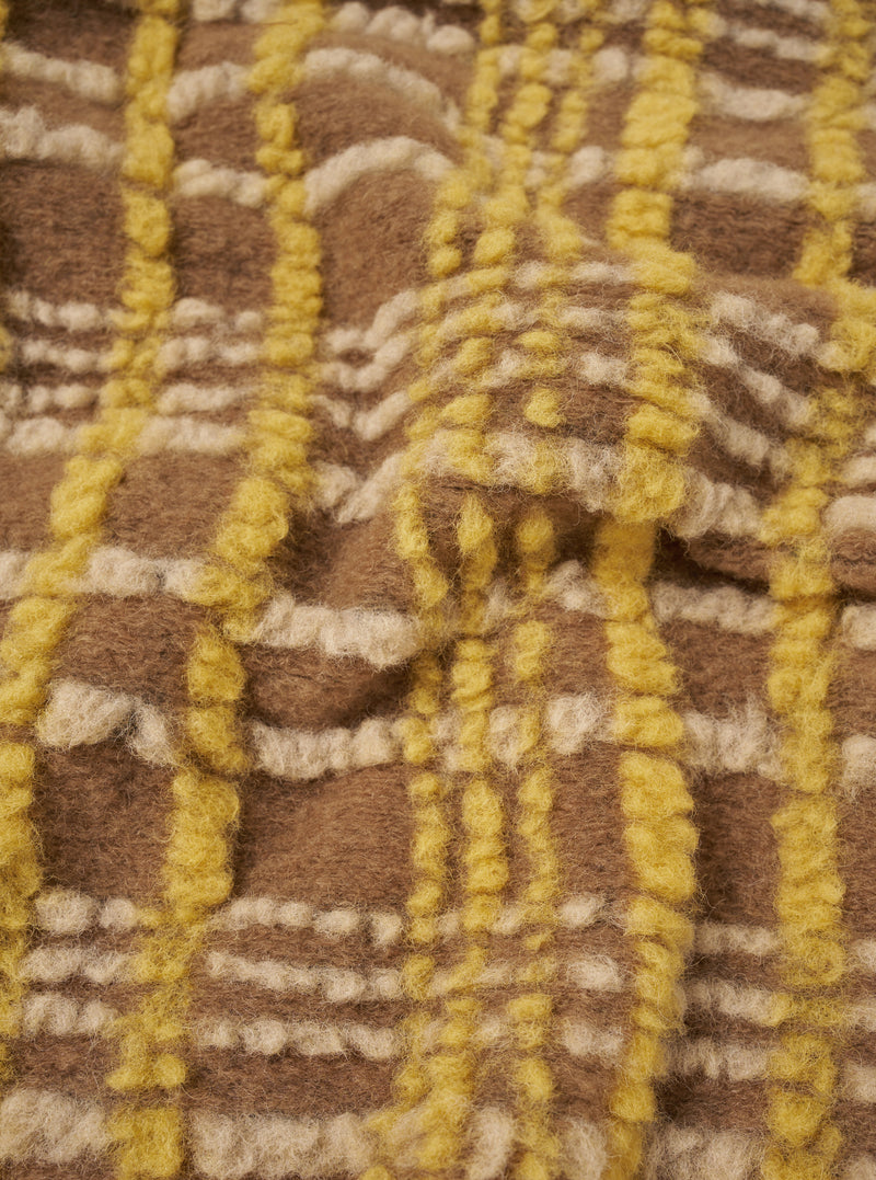 A detailed close-up swatch photograph showing the rich texture and fuzzy surface of the wool-blend fleece fabric on the Brown Duomo Fleece Cardigan against a plain white background.
