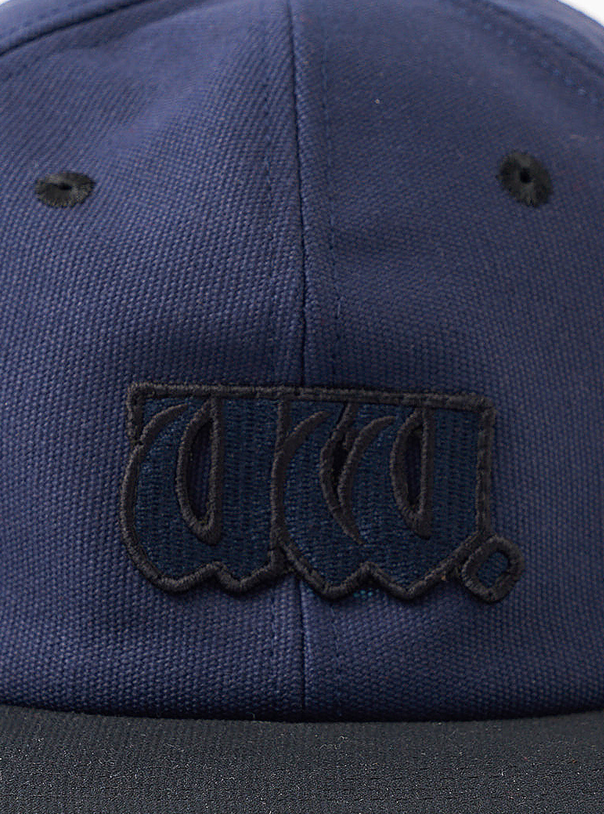A back view image of the Navy/Black Canvas Baseball Hat set against a plain white background. The image showcases the adjustable back strap with a metal buckle and the curved navy canvas crown panels.