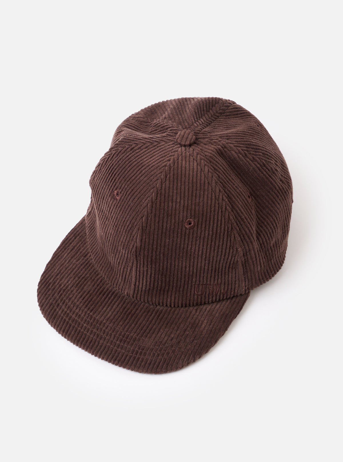 A side profile view of the Cacao Cord Baseball Hat shown against a white background. The photo highlights the ribbed corduroy texture, ventilation eyelet, and structured crown curve of the brown cap.