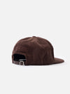 A close-up detail shot of the Cacao Cord Baseball Hat displayed on a white background. The photograph highlights the soft ribbed corduroy fabric, reinforced seam stitching, and tonal eyelet detail.