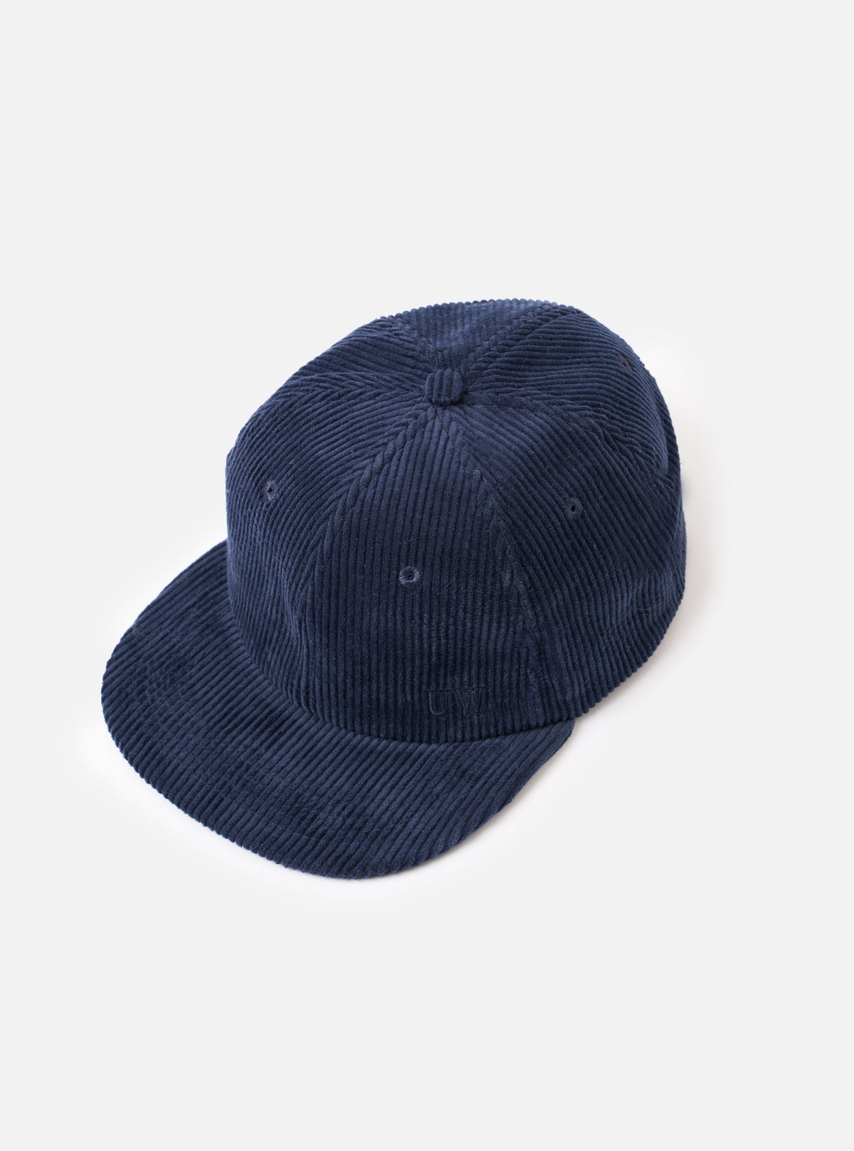 A side profile view of the Dark Navy Cord Baseball Hat shown on a white background. The photo emphasizes the dark navy ribbed corduroy fabric, structured crown shape, and ventilation eyelets.