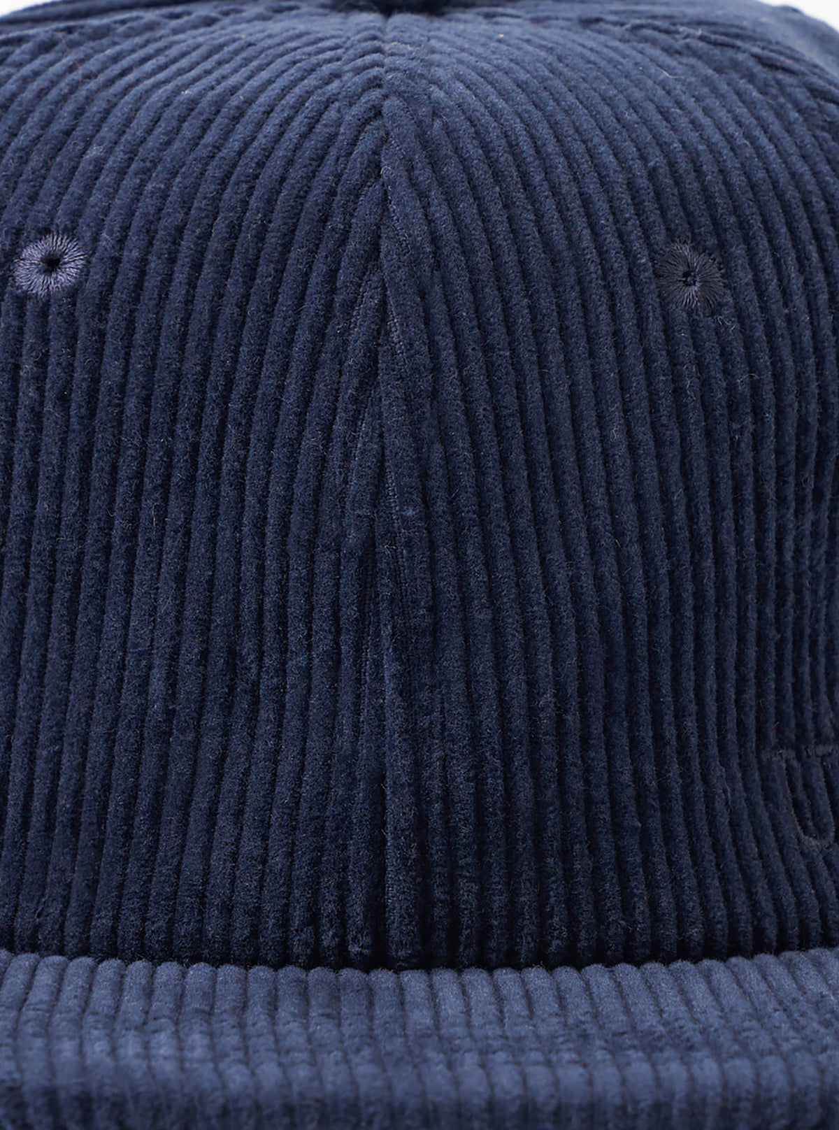 A back view image of the Dark Navy Cord Baseball Hat set against a white background. The shot highlights the adjustable rear strap with a metal clasp and neat paneling across the dark navy corduroy.