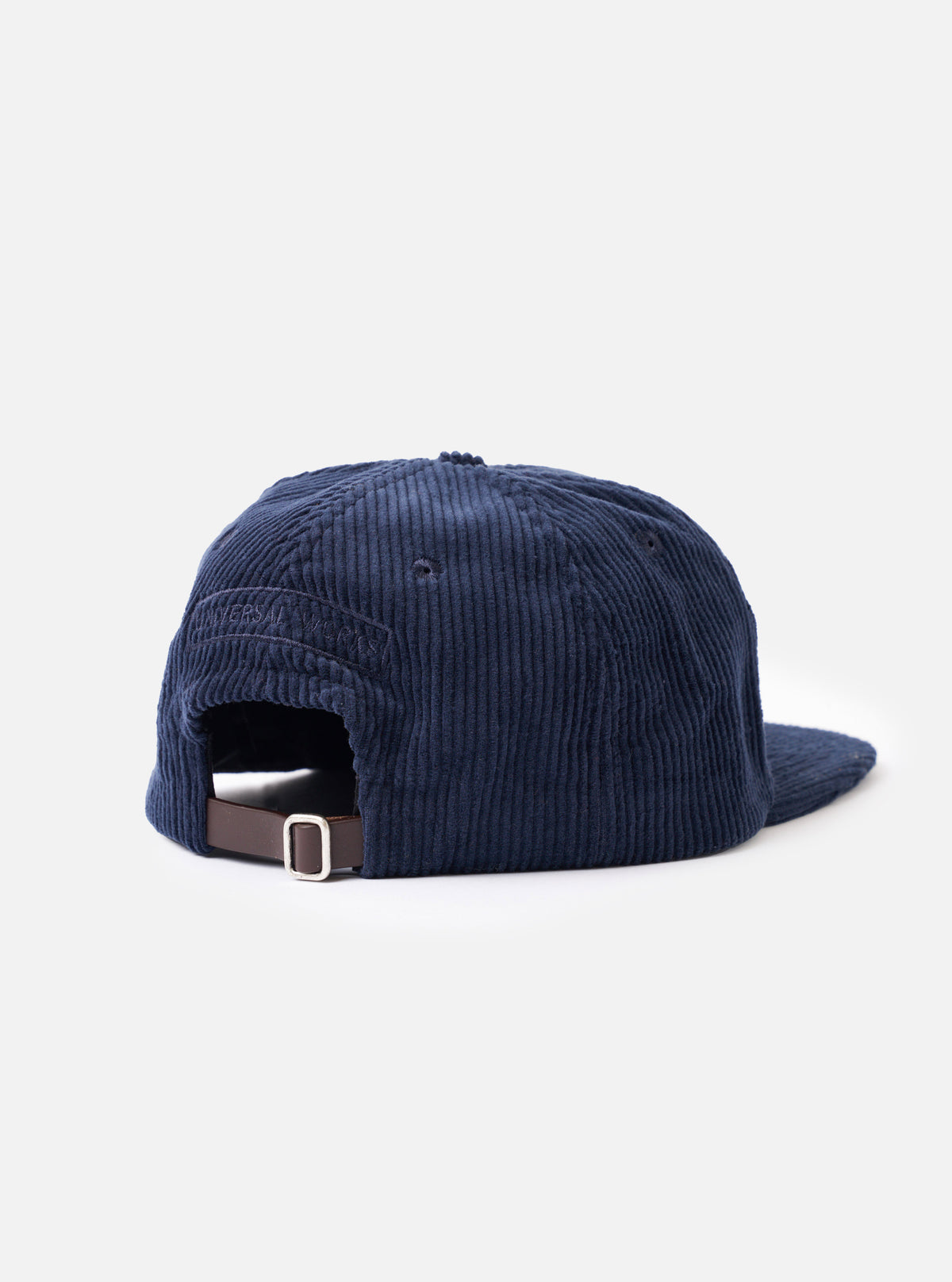 A close-up detail photograph of the Dark Navy Cord Baseball Hat on a plain white background. The shot focuses on the detailed texture of the dark navy corduroy fabric and precise seam stitching.