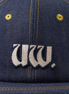 A rear view image of the Indigo 13oz Selvedge Denim Baseball Hat set on a plain white background. The focus is on the adjustable back strap with a metallic buckle and the dark indigo denim panels.