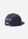 A detailed close-up image of the back of the Indigo 13oz Selvedge Denim Baseball Hat against a clean white studio background, highlighting the adjustable back strap, brass buckle, and dark blue denim stitching.
