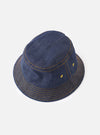 A side angle studio shot of the Indigo 13oz Selvedge Denim Lewis Hat set against a plain white background, showing the stitched downward brim, side ventilation eyelet, and structured crown of the dark indigo bucket hat.