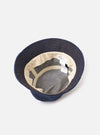 An interior view of the Indigo 13oz Selvedge Denim Lewis Hat on a white studio background, displaying the internal head tape, red selvedge seam detail, and clean inner construction of the dark blue bucket hat.