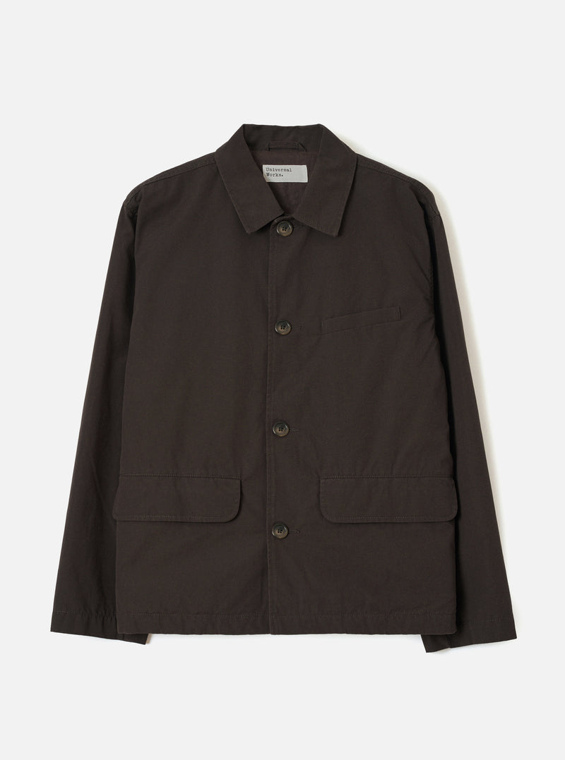 A front studio view of the Brown Micro Canvas Warmus Jacket displayed against a plain white background, featuring a classic collar, button-up front, chest welt pocket, and lower patch pockets in rich brown cotton canvas.