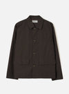 A front studio view of the Brown Micro Canvas Warmus Jacket displayed against a plain white background, featuring a classic collar, button-up front, chest welt pocket, and lower patch pockets in rich brown cotton canvas.