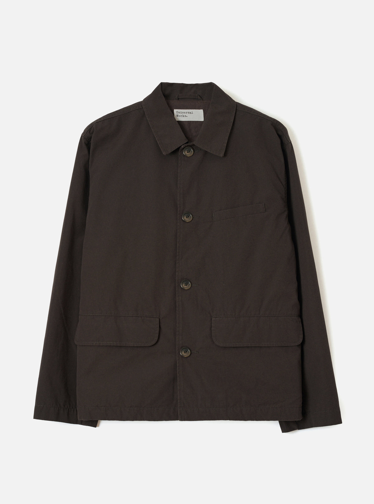 A front studio view of the Brown Micro Canvas Warmus Jacket displayed against a plain white background, featuring a classic collar, button-up front, chest welt pocket, and lower patch pockets in rich brown cotton canvas.