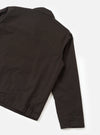 A back view studio photograph of the Brown Micro Canvas Warmus Jacket set against a plain white backdrop, highlighting the clean shoulder yoke, straight hem cut, and durable brown cotton micro canvas fabric.