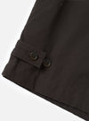 A close-up view of the Brown Micro Canvas Warmus Jacket on a white studio background, focusing on the front button closure, detailed stitching on the chest welt pocket, and smooth brown cotton canvas fabric.