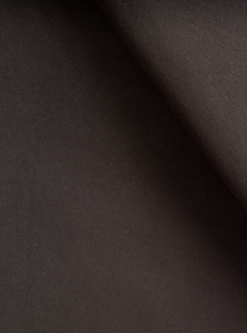 A close-up fabric swatch image of the Brown Micro Canvas Warmus Jacket on a plain white background, showing the fine weave texture, smooth surface finish, and rich shade of the brown cotton canvas material.