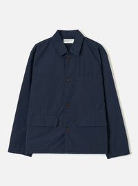 A front studio view of the Navy Micro Canvas Warmus Jacket set against a plain white background, featuring a classic pointed collar, button closure, chest pocket, and flap lower pockets in dark navy blue cotton canvas.