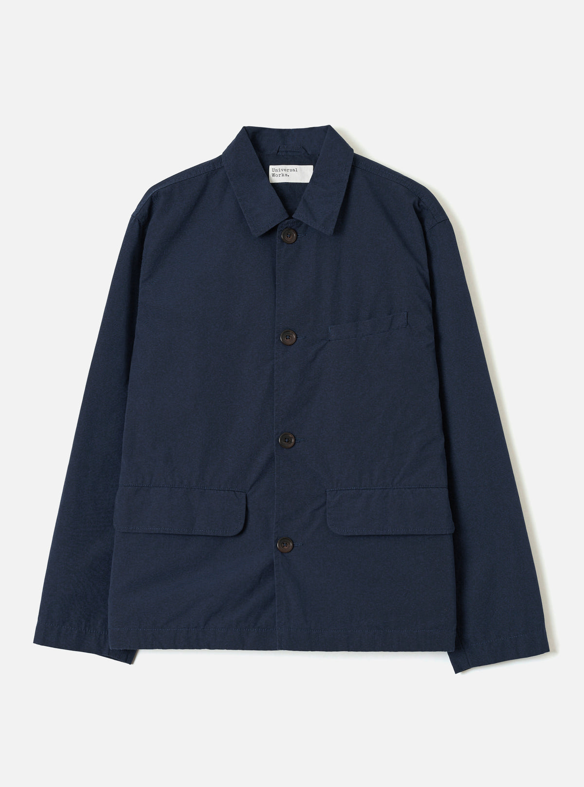 A front studio view of the Navy Micro Canvas Warmus Jacket set against a plain white background, featuring a classic pointed collar, button closure, chest pocket, and flap lower pockets in dark navy blue cotton canvas.