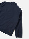 A rear perspective studio photograph of the Navy Micro Canvas Warmus Jacket against a clean white backdrop, showcasing the smooth back construction, shoulder seam stitching, and dark navy cotton canvas material.