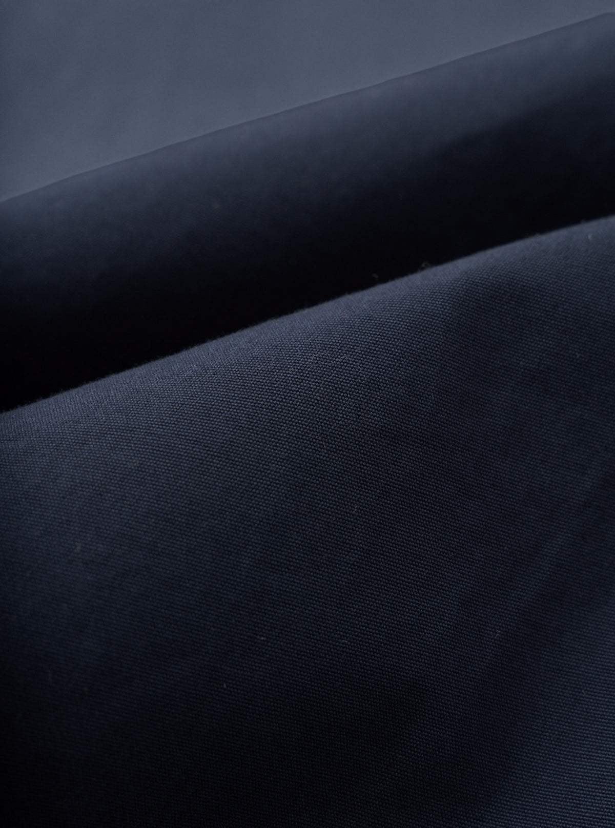 A close-up fabric swatch image showcasing the fine texture of the Navy Micro Canvas Military Chino on a plain white background, highlighting the tight cotton weave and rich navy blue colorway of the material.