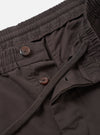 Detailed close-up view of the Brown Micro Canvas Oxford Pant on a clean studio background. The photo highlights the drawstring waistband, pleat construction, side seam pockets, and detailed brown cotton micro-canvas fabric texture.