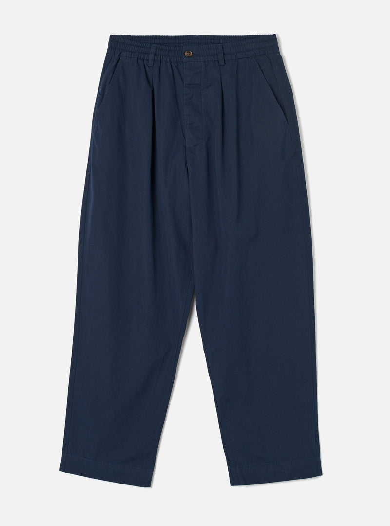 Front view photograph of the Navy Micro Canvas Oxford Pant on a plain white studio backdrop. The image demonstrates the loose wide-leg cut, drawstring waist, front pleating, and dark navy blue micro-canvas cotton material.