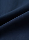 A detailed fabric swatch photograph of the Navy Micro Canvas Oxford Pant displayed on a plain white background, showcasing the rich navy blue color and smooth micro-canvas texture of the cotton fabric.