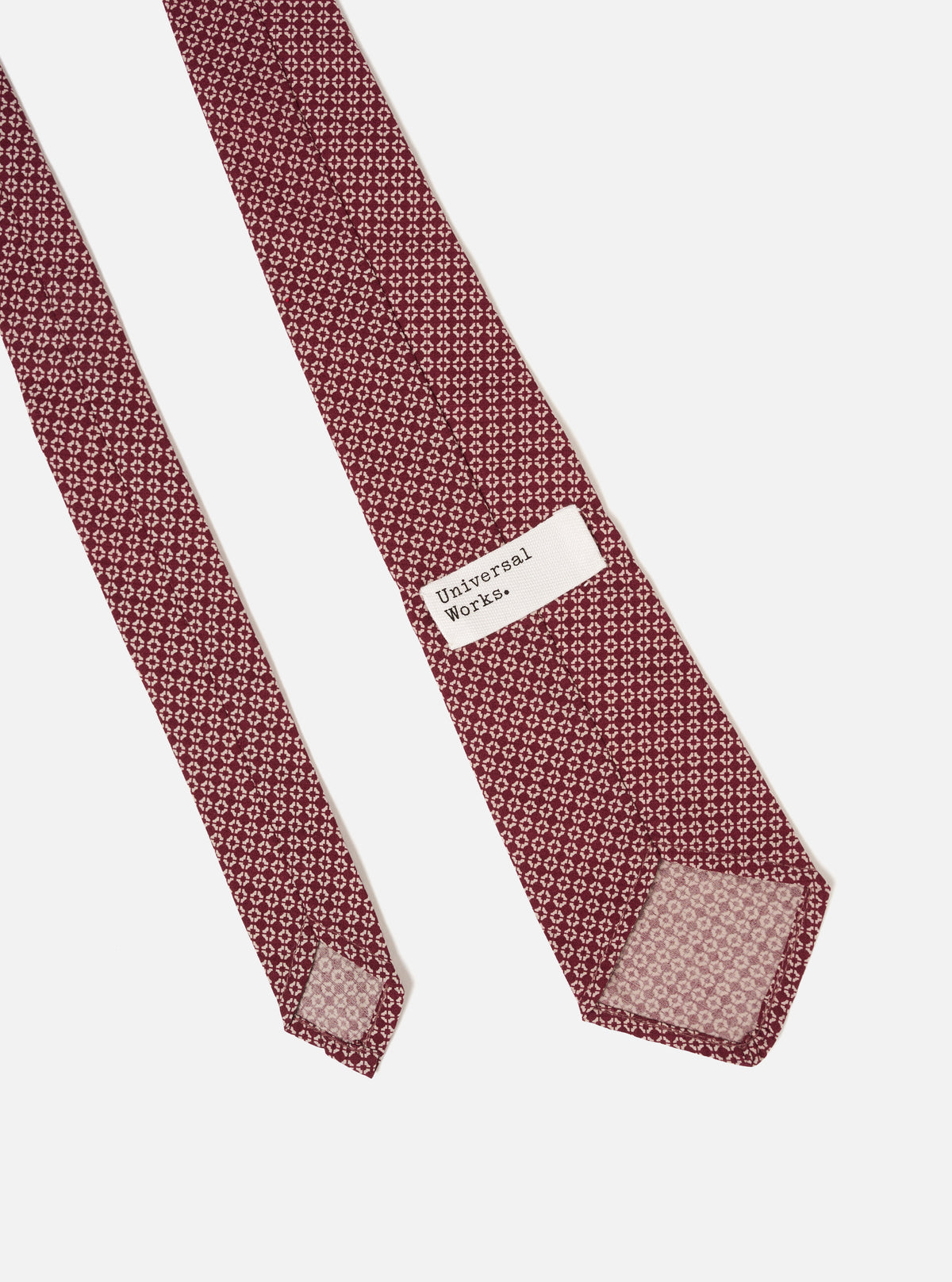 Full-length view of the Brown Regal Cotton Tie arranged flat against a white background, demonstrating the classic length, tapered cut, and soft drape of the viscose polyester blend fabric.
