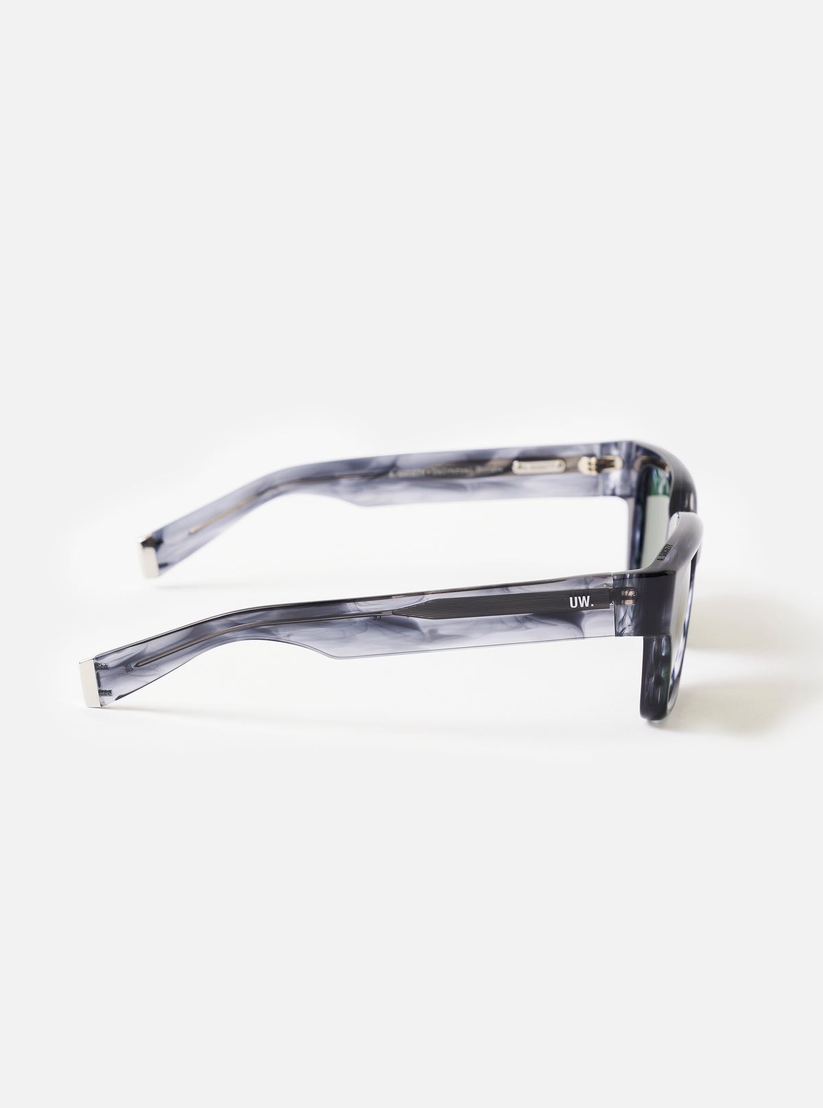 Three-quarter angle shot of the A. SOCIETY x Universal Works Grey Havana Hollywood Sunglasses on a white backdrop, highlighting the bridge shape, lens shape, and grey mottled tortoiseshell finish.