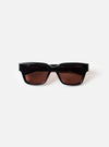 Front view product shot of the A. SOCIETY x Universal Works Black Hollywood Sunglasses set against a plain white backdrop, highlighting the thick black frame and dark tinted lenses.