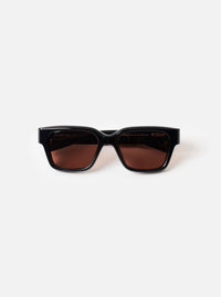 Front view product shot of the A. SOCIETY x Universal Works Black Hollywood Sunglasses set against a plain white backdrop, highlighting the thick black frame and dark tinted lenses.