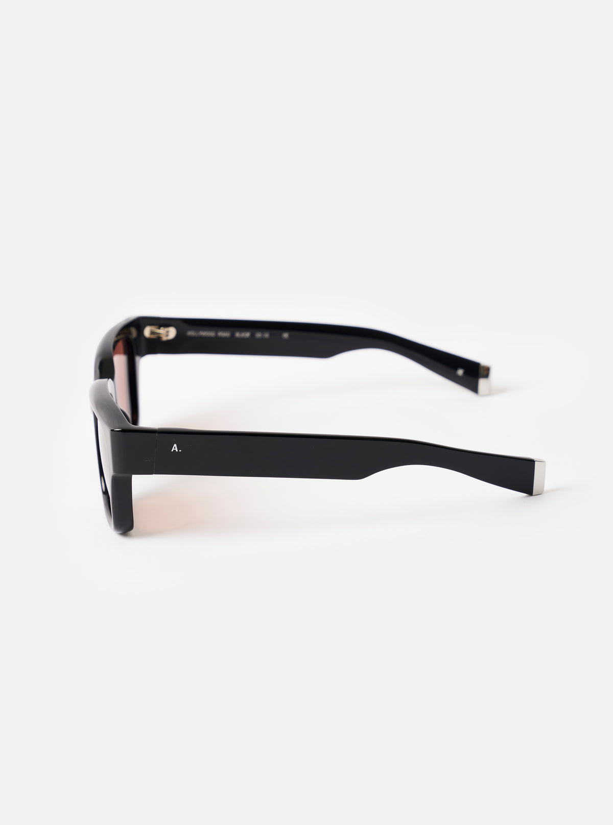 Close-up detailed shot of the inner frame and arm of the A. SOCIETY x Universal Works Black Hollywood Sunglasses on a neutral background, emphasizing the fine branding and construction.
