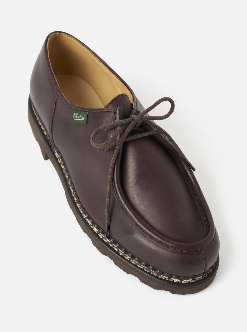 A detailed studio view of the Paraboot Cafe Leather Michael Marche II shoe against a plain light background, featuring rich dark brown leather uppers, sturdy Norwegian welt stitching, and a durable rubber outsole.