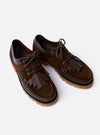 The Paraboot x Universal Works Thiers/Jannu in Café Leather/Suede is shown from a rear angle as a flat lay against a white background. The image highlights the deep brown café color and the contrast between the smooth leather and the textured suede-like reverse on the heel and collar. The piped seams and the thick vulcanized natural rubber sole are clearly visible.