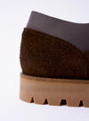 The Paraboot x Universal Works Thiers/Jannu in Cafe Leather/Suede is shown in a side profile view as a flat lay against a plain white background. The shoe features a dark brown cafe leather upper with a suede heel counter and a textured kiltie fringe over the laces. It is constructed with four eyelets, piped seams, and a thick vulcanized natural rubber sole.