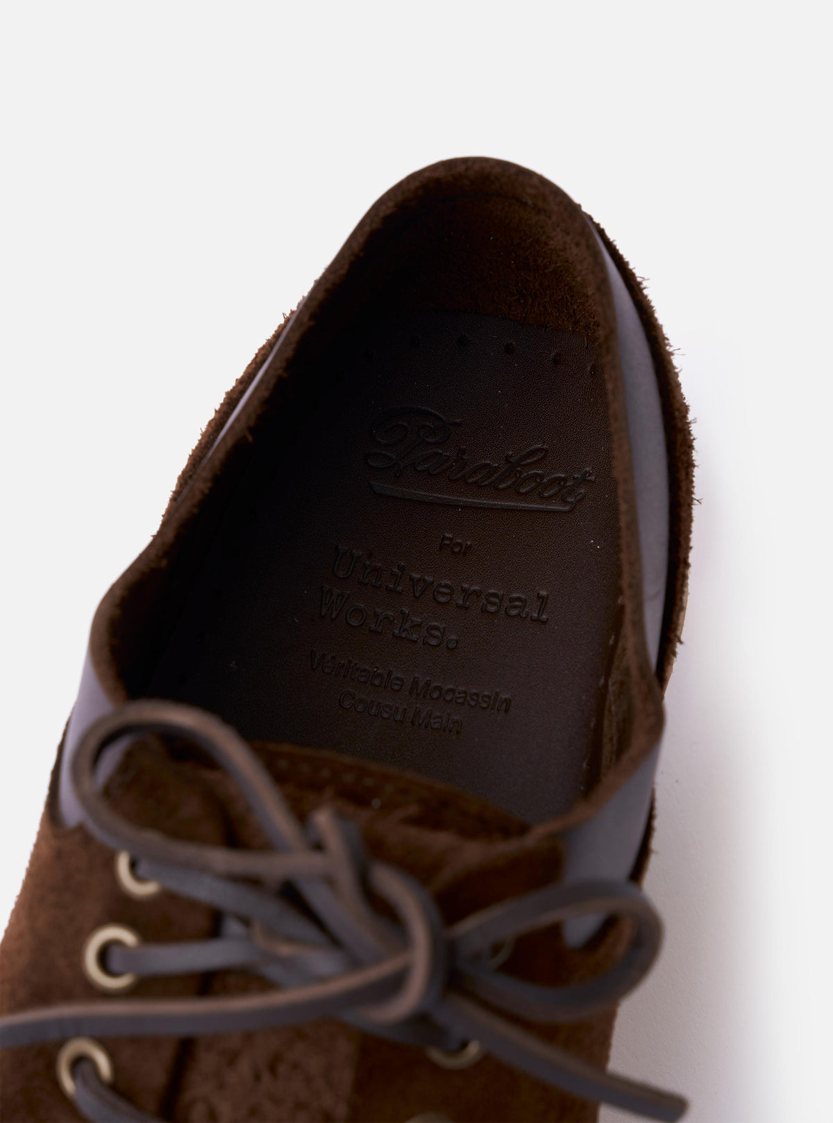 The Paraboot x Universal Works Thiers/Jannu in Café Leather/Suede is shown as a flat lay against a white background. The shoe features a deep brown leather and suede upper with piped seams, four eyelet laces, and a chunky natural rubber sole. A removable kiltie-style fringe covers the laces.