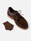 The Paraboot x Universal Works Thiers/Jannu in Café Leather/Suede is shown from a high-angle view as a flat lay against a plain white background. The shoe features a dark brown leather and suede upper with a distinctive moccasin-style toe, four-eyelet lacing, and a thick, gum-colored vulcanized natural rubber sole.