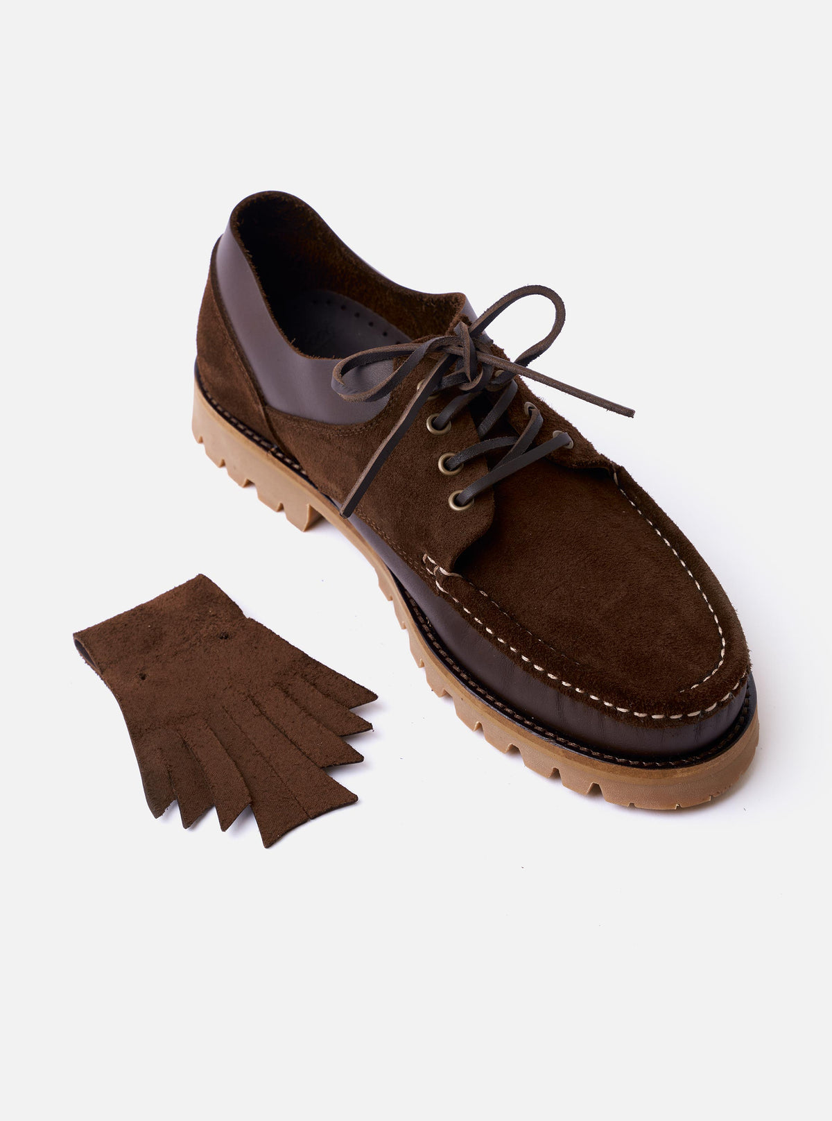 The Paraboot x Universal Works Thiers/Jannu in Café Leather/Suede is shown from a high-angle view as a flat lay against a plain white background. The shoe features a dark brown leather and suede upper with a distinctive moccasin-style toe, four-eyelet lacing, and a thick, gum-colored vulcanized natural rubber sole.