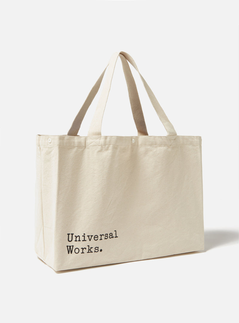 Studio shot of an Ecru Cotton Canvas Tote Bag. The bag is ecru colored with matching handles. The background is a simple white.