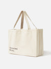 Studio shot of an Ecru Cotton Canvas Tote Bag. The bag is made of ecru cotton canvas with matching handles. The background is plain white.