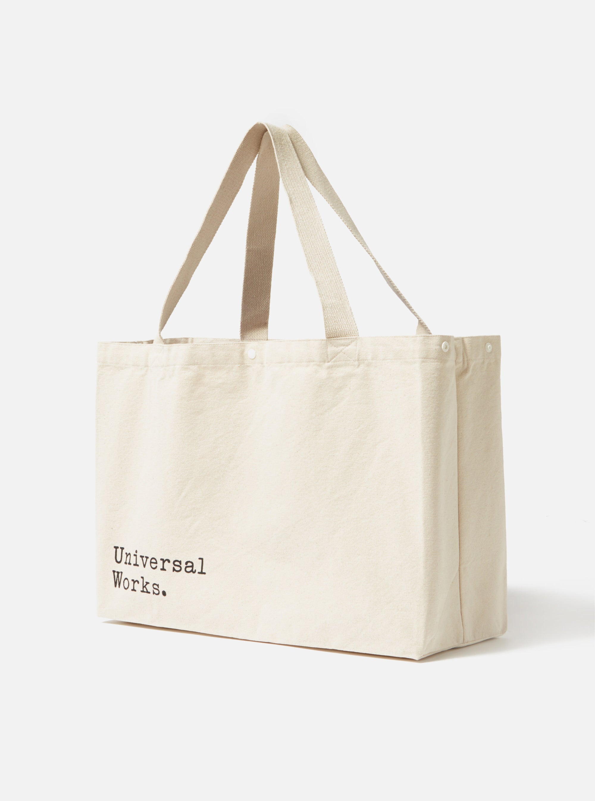 Studio shot of an Ecru Cotton Canvas Tote Bag. The bag is made of ecru cotton canvas with matching handles. The background is plain white.