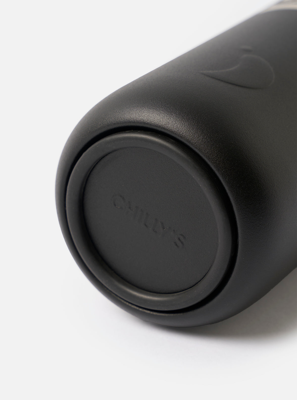 Studio shot of the Chilly's x Universal Works Onyx Series 3 500ml Water Bottle standing upright on a plain white background, highlighting its matte black finish, body, and secure lid.