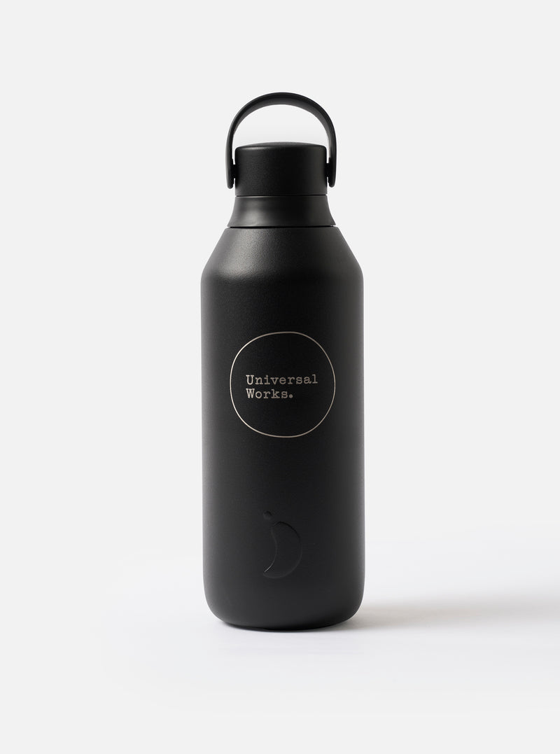 Detailed close-up image of the Chilly's x Universal Works Onyx Series 3 500ml Water Bottle against a solid white background, emphasizing the printed Universal Works logo on the matte body.