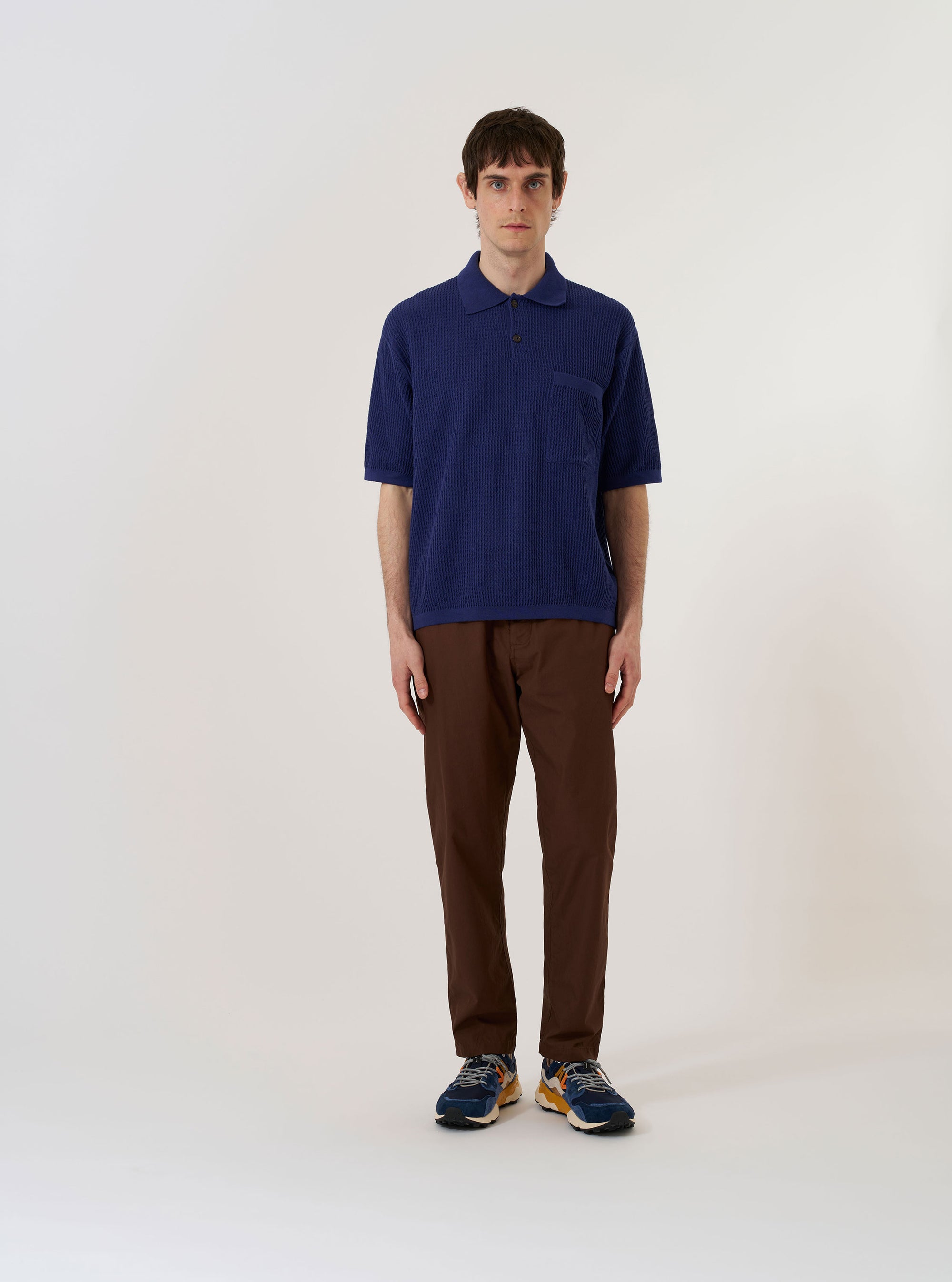 The Navy Fine Texture Tricot S/S Knit Polo is shown as a flat lay against a plain white background. The polo shirt features a classic collar, a three-button placket, and short sleeves. The dark navy fabric has a detailed tricot knit texture, and the collar and sleeve cuffs are finished with fine ribbing.