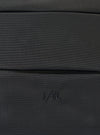 Close-up of the F/CE.® Black 420 re/cor Sacoche. The black textured material is visible. The F/CE logo is embroidered on the bottom. Shot on a flat surface.