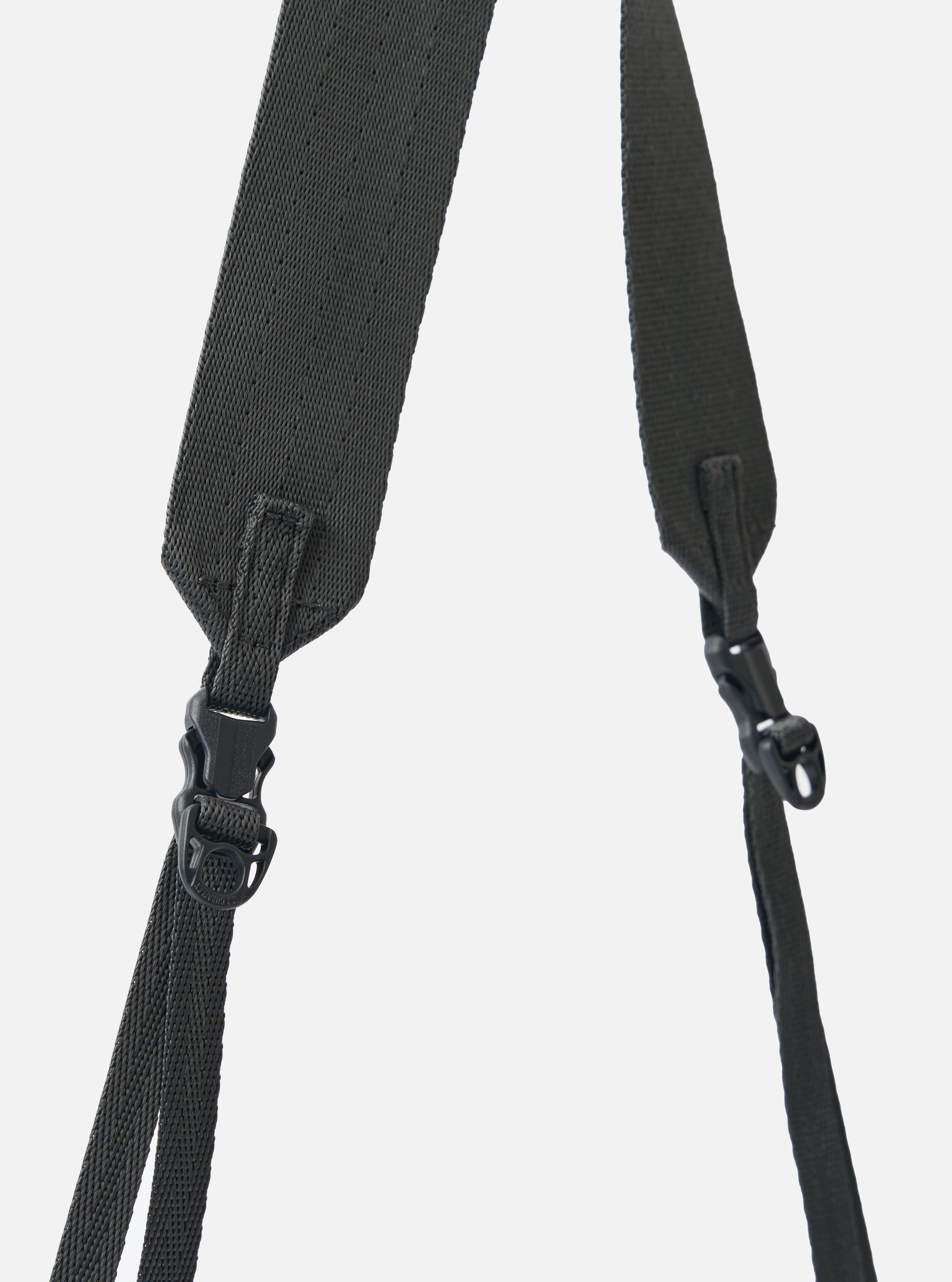 Close-up of the grey woven straps and black plastic buckles of the F/CE.® Grey 420 re/cor Sacoche against a plain white backdrop.
