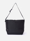 The F/CE. Black Recycled Nylon 420 re/cor Courier Shoulder Bag is shown from the back as a flat lay against a plain white background. The image highlights the wide, adjustable messenger-style shoulder strap and the smooth, technical texture of the black recycled nylon fabric.