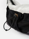 Close-up of the F/CE.® White Nylon Cordura Sil Sacoche showing the black mesh pocket, white nylon interior, and drawstring closure on a white background.