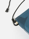 Close-up of the master-piece x Universal Works Blue Camo Recycled Tech Canvas Sacoche. Shows the blue camo pattern, black rope strap, and metal hardware on a white background.