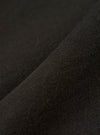 A close-up fabric swatch of the master-piece x Universal Works Black Single Jersey Print Tee highlights the solid black color and the smooth, fine-knit texture of the single jersey cotton fabric.